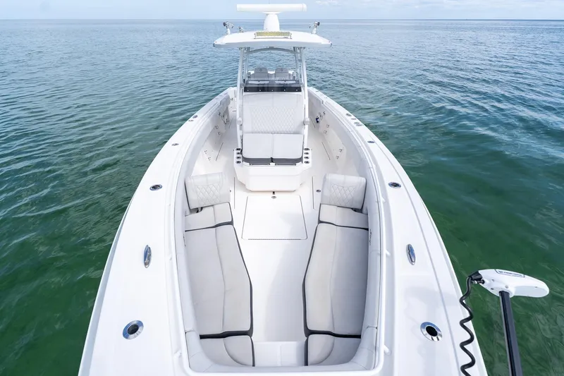Slide: The Image of 2021 Fountain 38 Center Console boat on calm water, showcasing spacious seating and sleek design. - 19