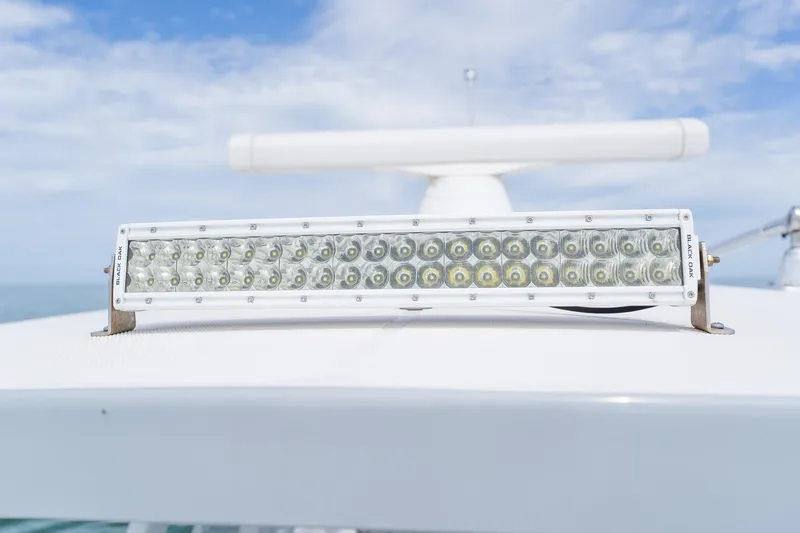 Slide: The Image of LED light bar on 2021 Fountain 38 Center Console boat under blue sky. - 24