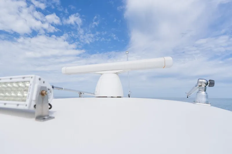 Slide: The Image of 2021 Fountain 38 Center Console radar and equipment against a blue sky backdrop. - 25