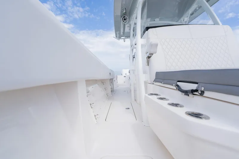 Slide: The Image of 2021 Fountain 38 Center Console boat interior with sleek white design and seating. - 27