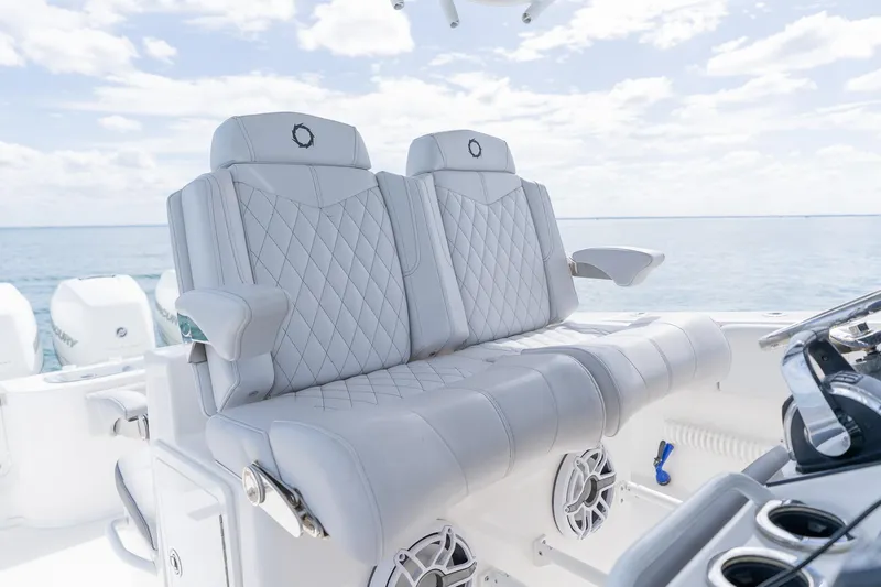 Slide: The Image of Luxurious seating on a 2021 Fountain 38 Center Console boat with ocean backdrop. - 30