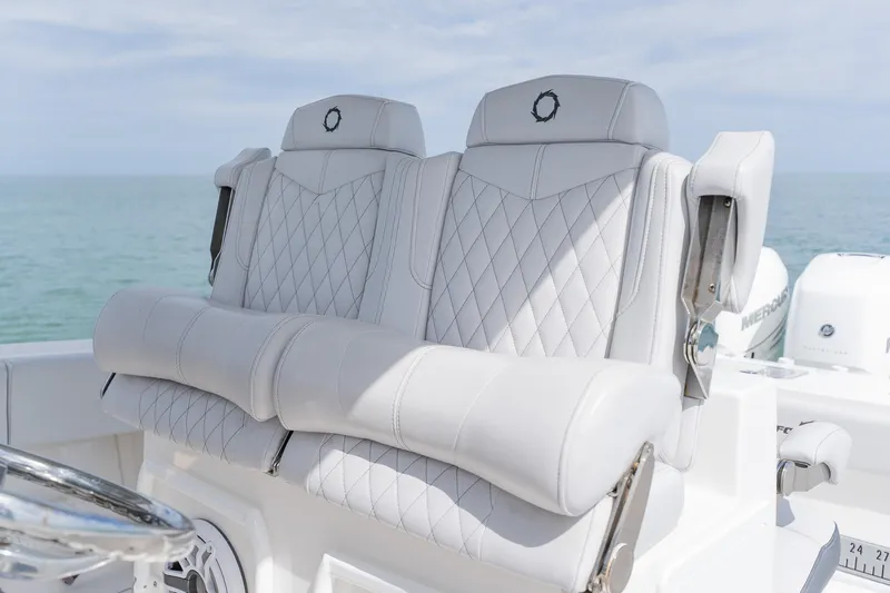 Slide: The Image of Luxurious seating on a 2021 Fountain 38 Center Console boat with ocean backdrop. - 31