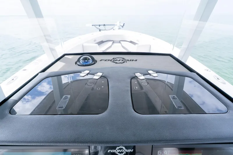 Slide: The Image of 2021 Fountain 38 Center Console boat dashboard with compass and storage compartments. - 35