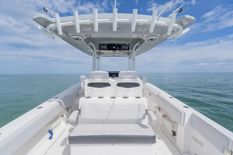 Slide: The Image of 2021 Fountain 38 Center Console boat on calm ocean waters under blue sky. - 38