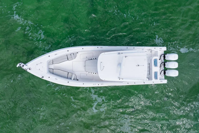 Slide: The Image of Aerial view of 2021 Fountain 38 Center Console boat on green water. - 4