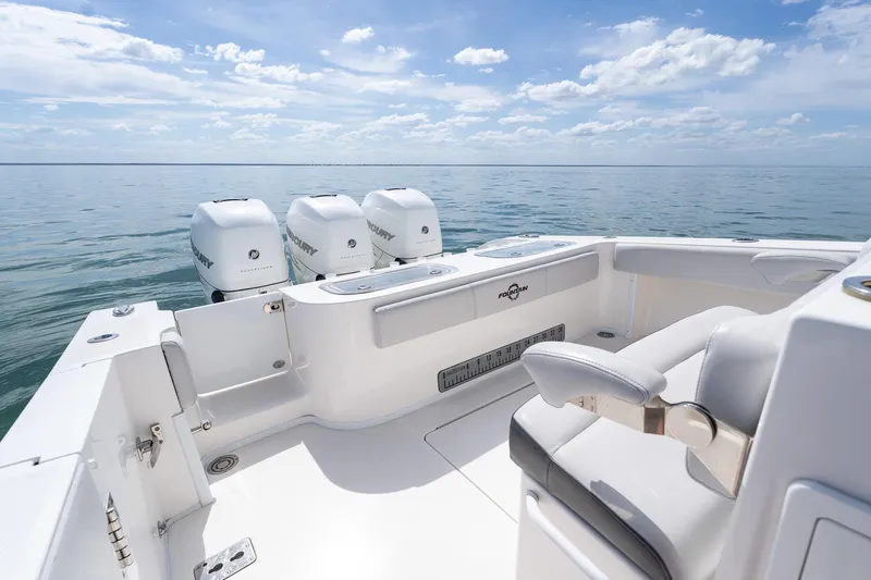Slide: The Image of 2021 Fountain 38 Center Console boat with triple Mercury engines on calm sea. - 42
