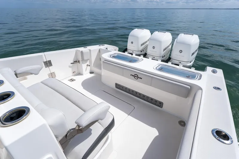 Slide: The Image of 2021 Fountain 38 Center Console boat with triple Mercury engines on calm sea. - 43