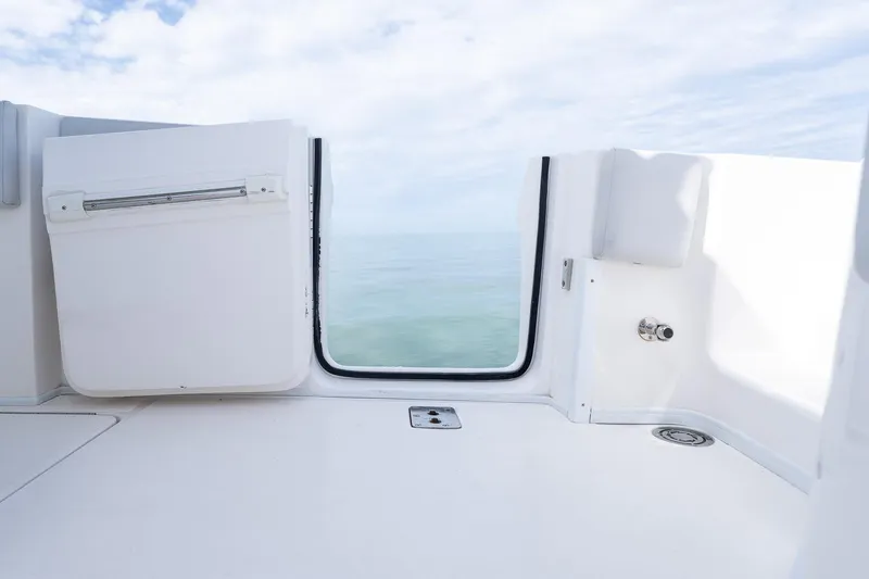 Slide: The Image of 2021 Fountain 38 Center Console boat interior with ocean view through open hatch. - 47