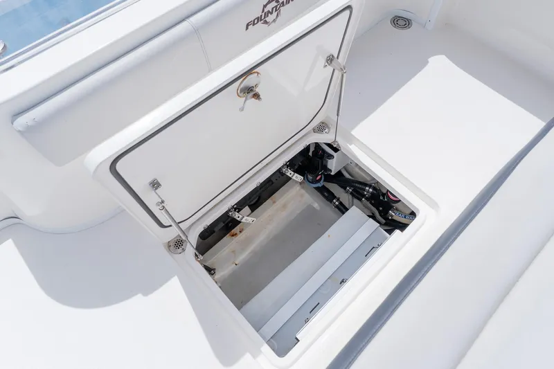 Slide: The Image of Open hatch on 2021 Fountain 38 Center Console boat, revealing internal components. - 48
