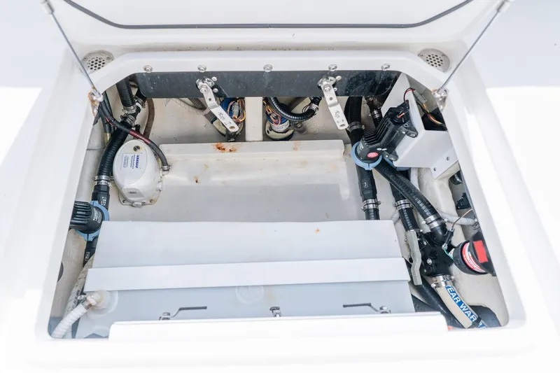 Slide: The Image of Engine compartment of a 2021 Fountain 38 Center Console boat, showcasing wiring and components. - 49