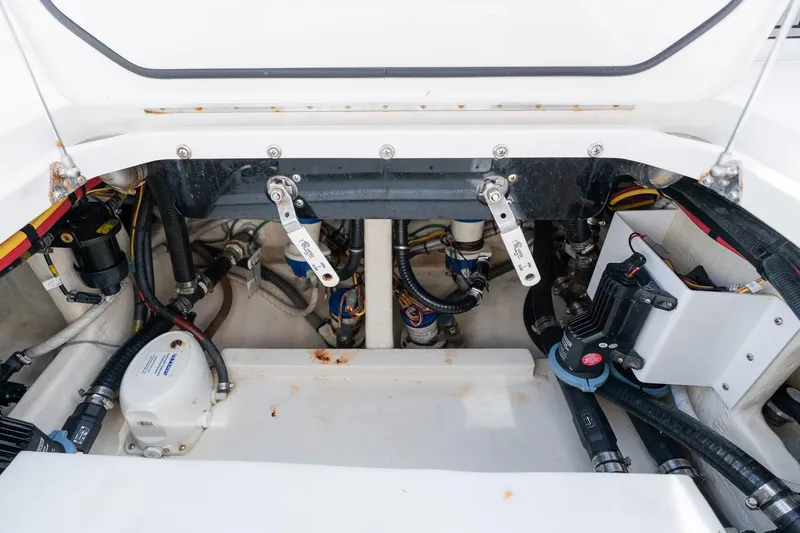 Slide: The Image of Engine compartment of a 2021 Fountain 38 Center Console boat, showcasing mechanical components. - 52