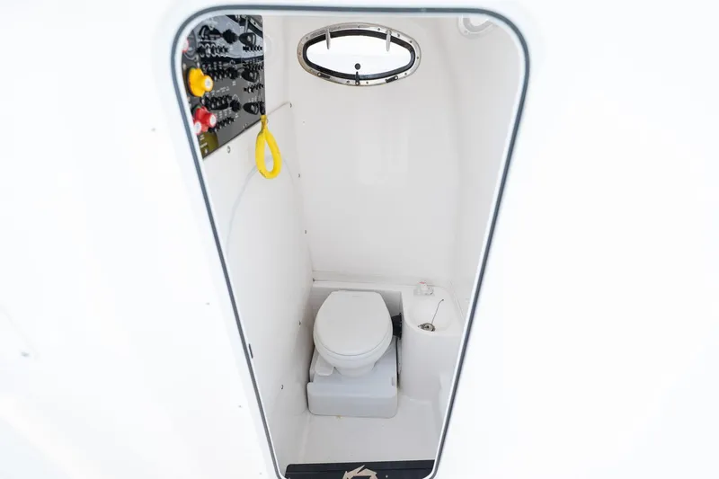 Slide: The Image of Interior of 2021 Fountain 38 Center Console boat's compact bathroom. - 53