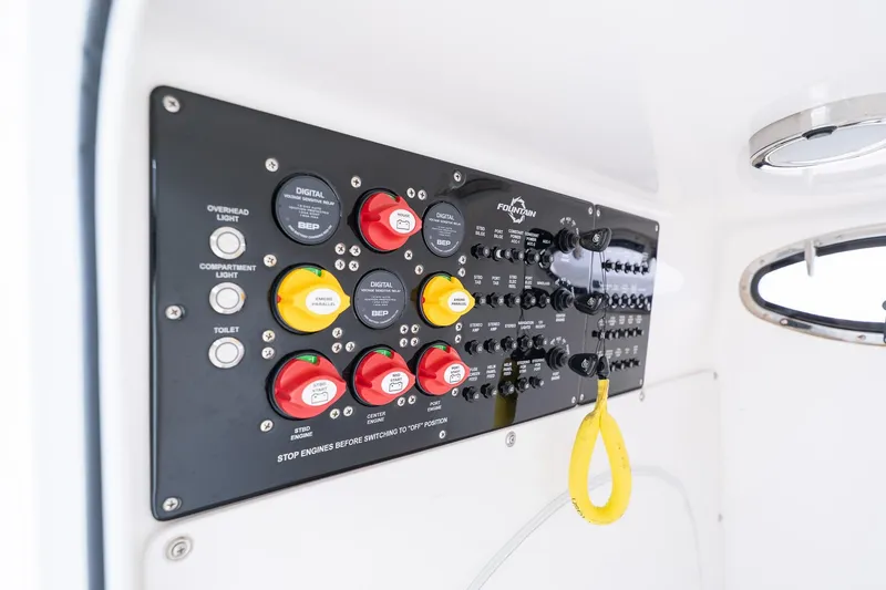 Slide: The Image of Control panel of a 2021 Fountain 38 Center Console boat with switches and buttons. - 54