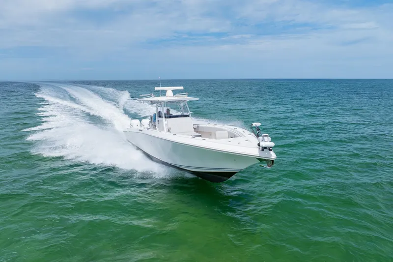 Slide: The Image of 2021 Fountain 38 Center Console boat cruising on open sea. - 9