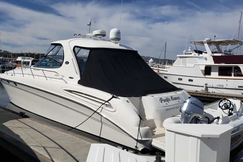 The Image of 2004 Sea Ray 550 Sundancer yacht docked at marina, featuring sleek design and modern amenities. - 1