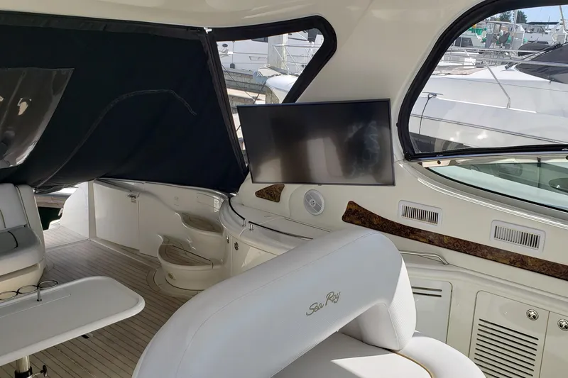 Slide: The Image of Interior of 2004 Sea Ray 550 Sundancer yacht with seating and mounted TV. - 10