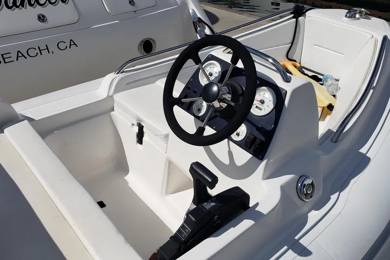 Slide: The Image of Steering console of a 2004 Sea Ray 550 Sundancer boat, featuring gauges and controls. - 100