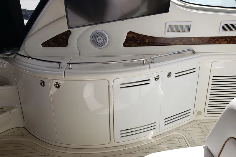 Slide: The Image of Interior view of a 2004 Sea Ray 550 Sundancer yacht, featuring sleek cabinetry and speaker system. - 14