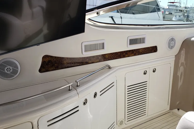 Slide: The Image of Interior view of 2004 Sea Ray 550 Sundancer yacht with speakers and storage cabinets. - 15