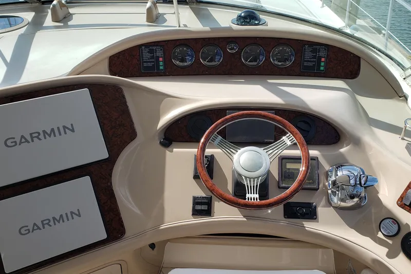 Slide: The Image of Helm of 2004 Sea Ray 550 Sundancer with Garmin navigation and wood-accented steering wheel. - 19