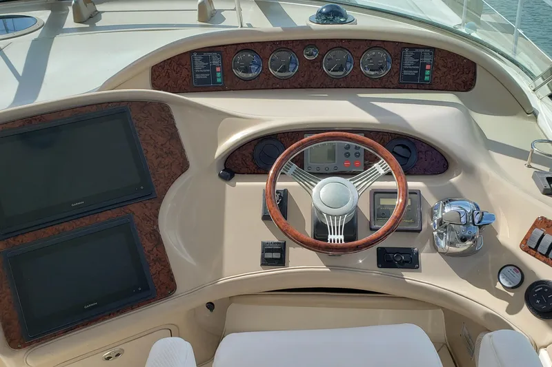 Slide: The Image of Helm of 2004 Sea Ray 550 Sundancer with wood accents and modern controls. - 20