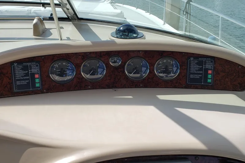 Slide: The Image of Dashboard of a 2004 Sea Ray 550 Sundancer yacht with gauges and controls. - 21