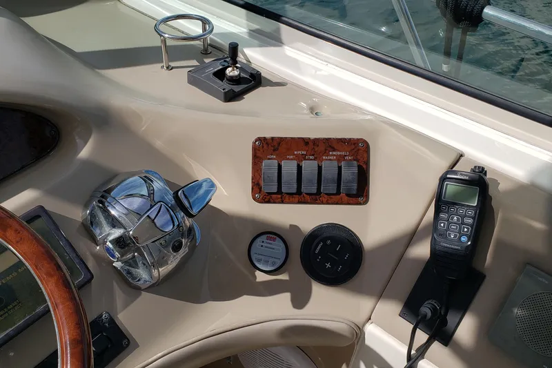 Slide: The Image of Control panel of a 2004 Sea Ray 550 Sundancer yacht with switches and radio. - 22