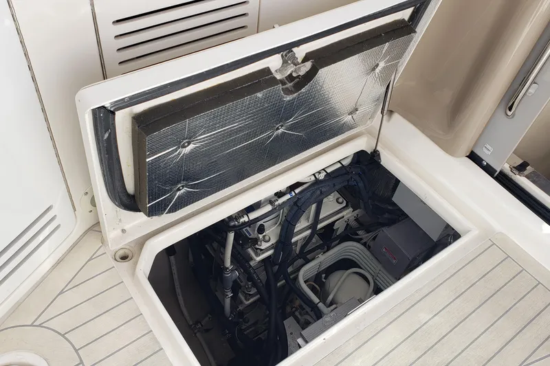 Slide: The Image of Engine compartment of a 2004 Sea Ray 550 Sundancer yacht, showcasing mechanical components. - 25