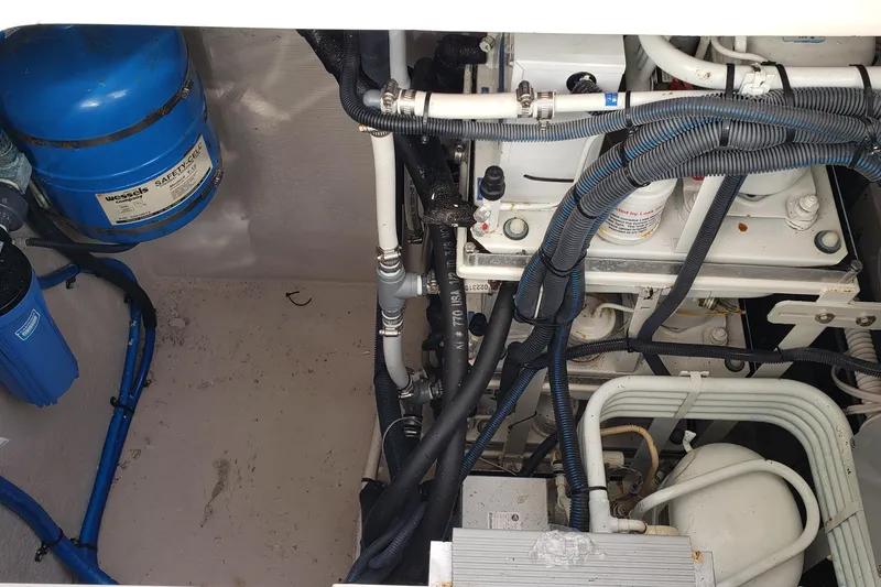 Slide: The Image of Engine room of 2004 Sea Ray 550 Sundancer with visible pipes and machinery. - 26