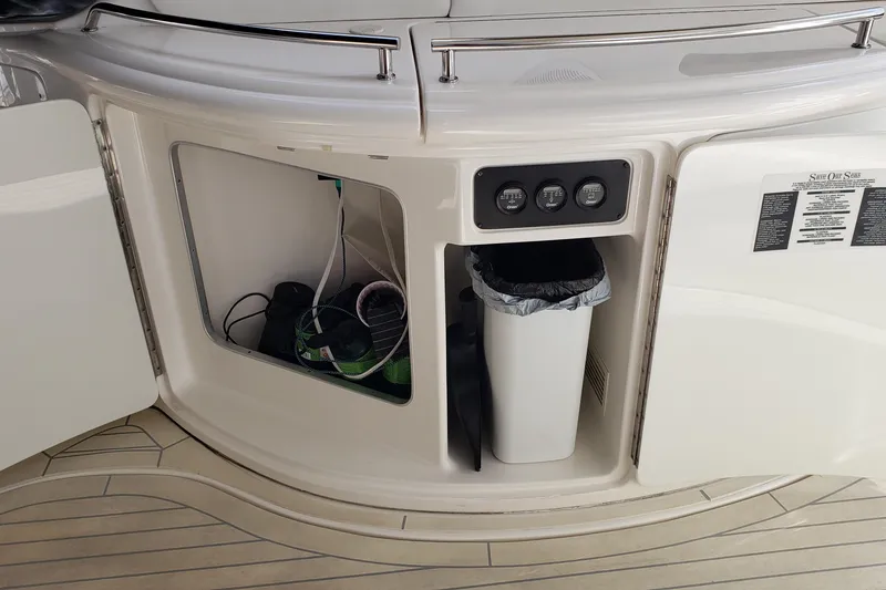 Slide: The Image of 2004 Sea Ray 550 Sundancer yacht interior storage with trash bin and control panel. - 28
