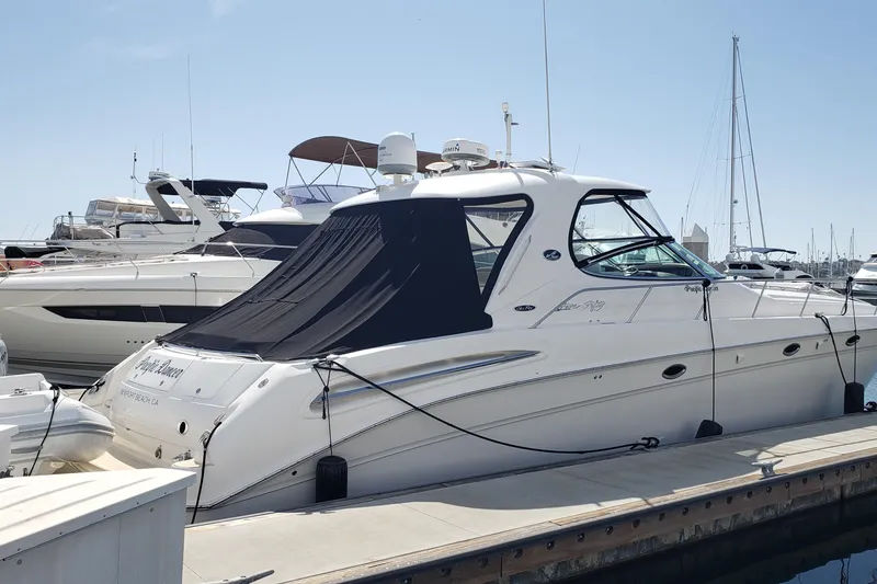 Slide: The Image of 2004 Sea Ray 550 Sundancer yacht docked at marina under clear blue sky. - 3
