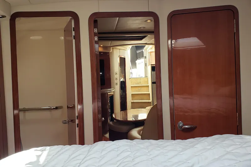 Slide: The Image of Interior view of 2004 Sea Ray 550 Sundancer yacht, featuring wooden doors and cozy cabin space. - 33