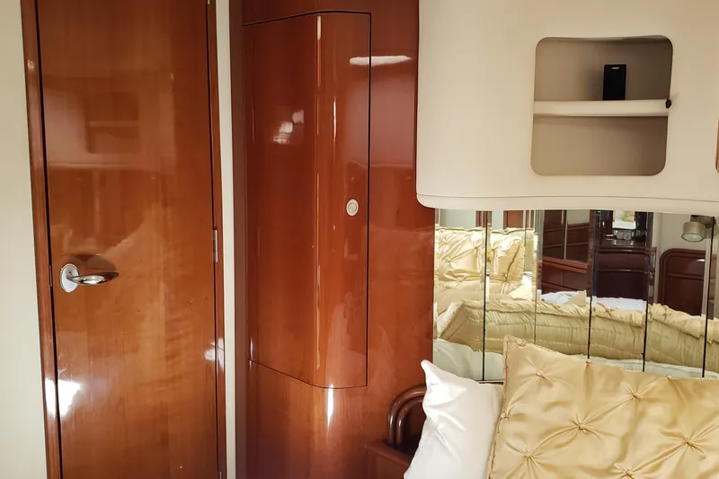 Slide: The Image of Luxurious interior of 2004 Sea Ray 550 Sundancer yacht with polished wood and plush bedding. - 36