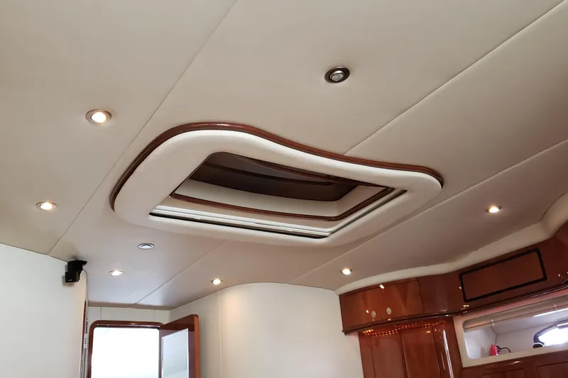 Slide: The Image of Interior ceiling of 2004 Sea Ray 550 Sundancer yacht with recessed lighting and wood accents. - 40