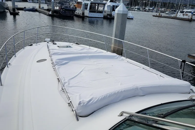 Slide: The Image of 2004 Sea Ray 550 Sundancer yacht docked at marina, featuring spacious deck area. - 41