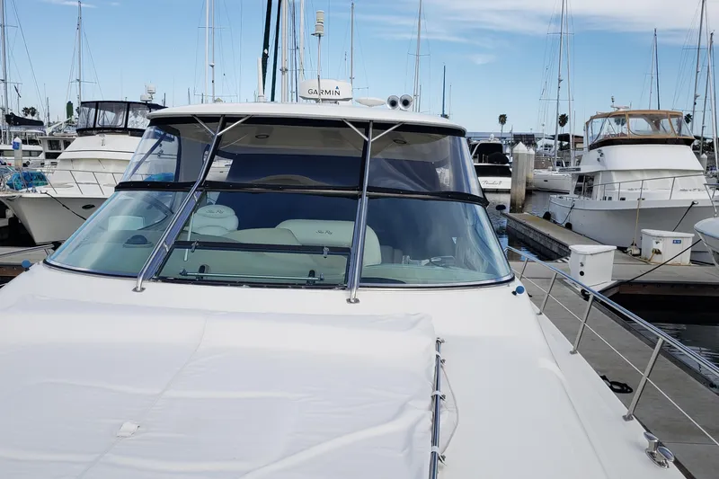 Slide: The Image of 2004 Sea Ray 550 Sundancer yacht docked at marina, surrounded by other boats. - 42