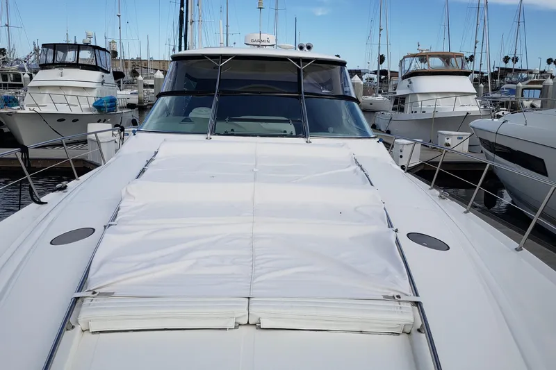 Slide: The Image of 2004 Sea Ray 550 Sundancer yacht docked in marina, surrounded by other boats. - 43