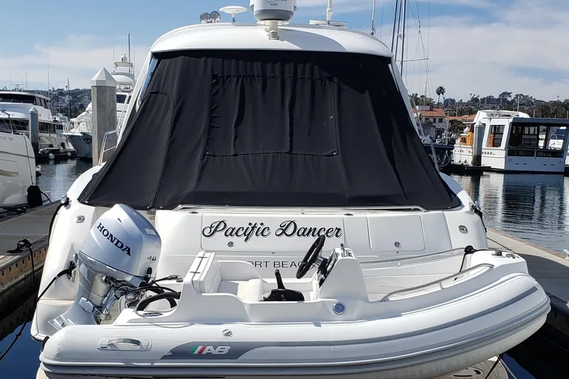 Slide: The Image of 2004 Sea Ray 550 Sundancer yacht docked with inflatable boat and Honda motor. - 51