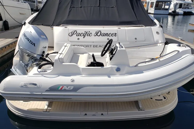 Slide: The Image of 2004 Sea Ray 550 Sundancer yacht with inflatable boat, docked in Newport Beach marina. - 52