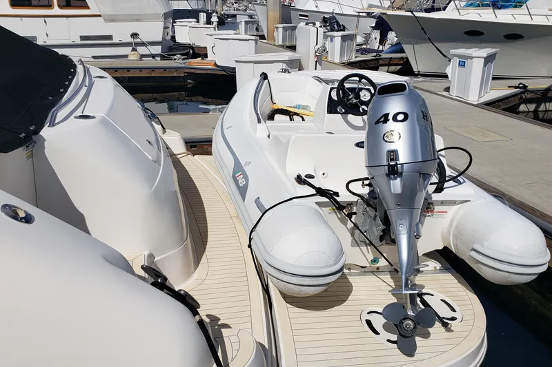 Slide: The Image of 2004 Sea Ray 550 Sundancer yacht with inflatable boat and outboard motor at marina. - 53