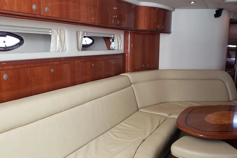 Slide: The Image of Luxurious interior of 2004 Sea Ray 550 Sundancer yacht with leather seating and wooden cabinetry. - 58