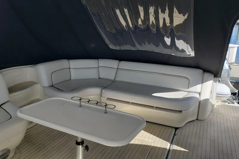 Slide: The Image of Luxurious seating area on 2004 Sea Ray 550 Sundancer yacht with table and canopy. - 6
