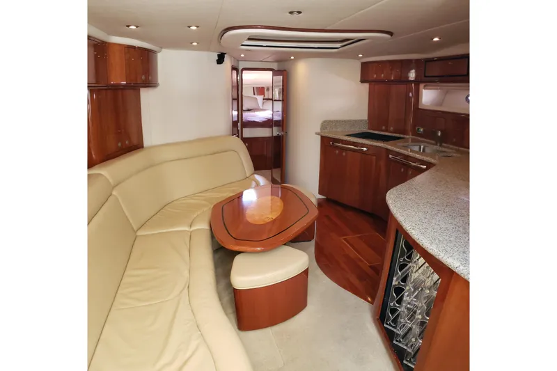 Slide: The Image of Luxurious interior of 2004 Sea Ray 550 Sundancer yacht with elegant seating and kitchen area. - 60