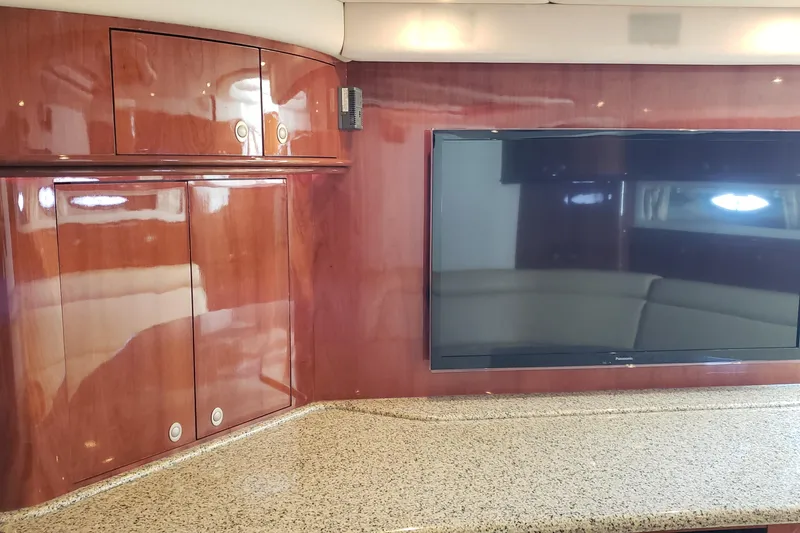 Slide: The Image of Luxurious interior of 2004 Sea Ray 550 Sundancer with wood cabinetry and flat-screen TV. - 64