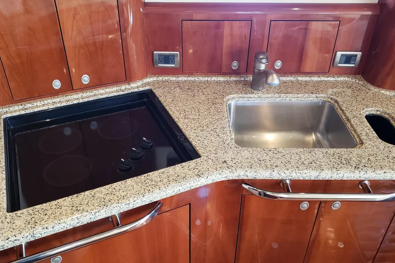 Slide: The Image of Luxurious 2004 Sea Ray 550 Sundancer yacht kitchen with granite countertop and modern appliances. - 65
