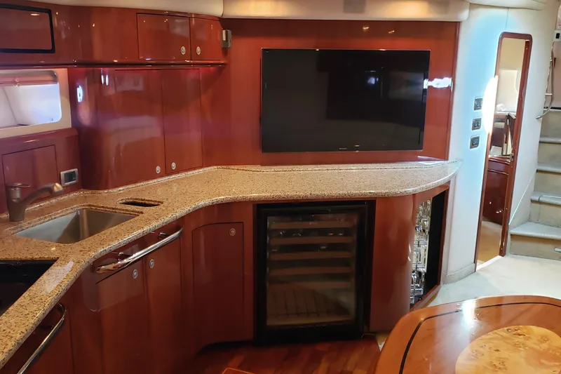 Slide: The Image of Luxurious interior of 2004 Sea Ray 550 Sundancer yacht with modern kitchen amenities. - 69