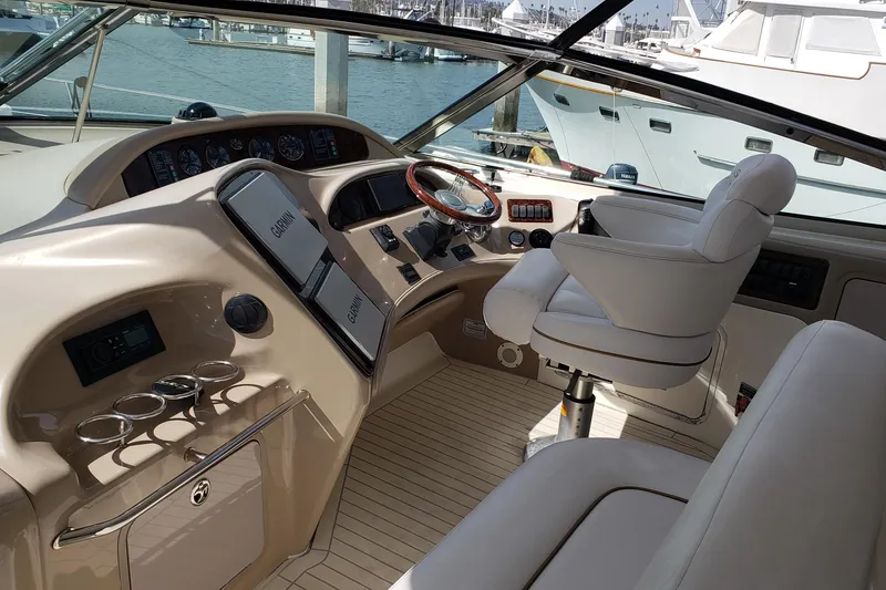Slide: The Image of 2004 Sea Ray 550 Sundancer helm with luxurious seating and advanced navigation systems. - 7