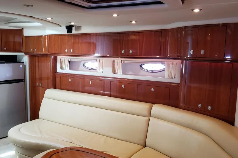 Slide: The Image of Luxurious interior of 2004 Sea Ray 550 Sundancer yacht with wood cabinets and leather seating. - 70