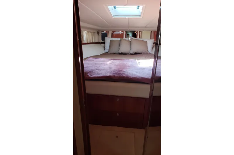 Slide: The Image of Luxurious cabin interior of 2004 Sea Ray 550 Sundancer yacht with plush bedding. - 71