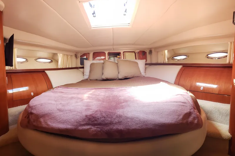 Slide: The Image of Luxurious cabin interior of 2004 Sea Ray 550 Sundancer yacht with plush bedding. - 72